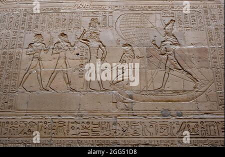 Engraved reliefs and hieroglyphics on a wall inside the Temple of Horus at Edfu in central Egypt. Stock Photo
