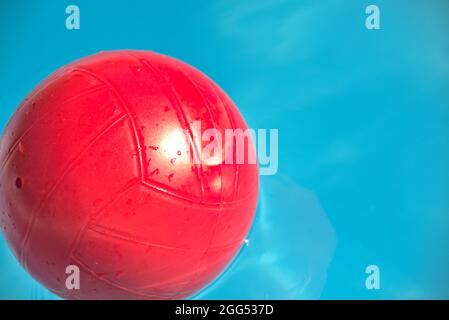 red ball floating in a pool Stock Photo
