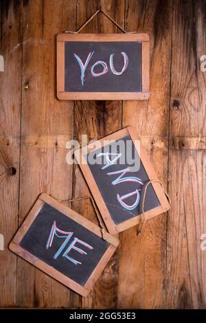 Graphic representation of the word, you and me, written with chalk on blackboard Stock Photo