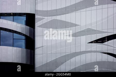 Combination of metal and glass wall material.  Abstract modern architecture. High-tech minimalist office building. Stock Photo