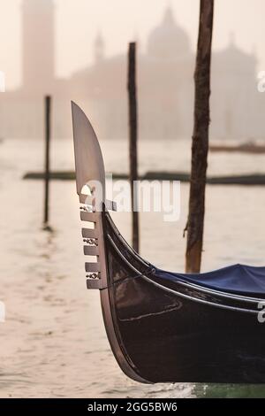 The iron prow-head of the gondola, called fero da prora or dolfin at sunrise Stock Photo