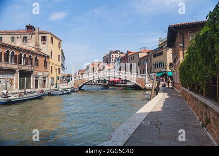 VENICE, ITALY - JUNE 15, 2016 View of the Ponte delle Guglie Bridge of Spires over the Canaregio Canal on a bright sunny day. A crowd of tourists on the bridge. Stock Photo