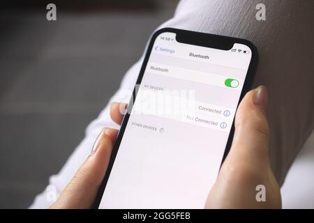 Turning on the Bluetooth settings on mobile phone, setting screen closeup, person using bluetooth Stock Photo