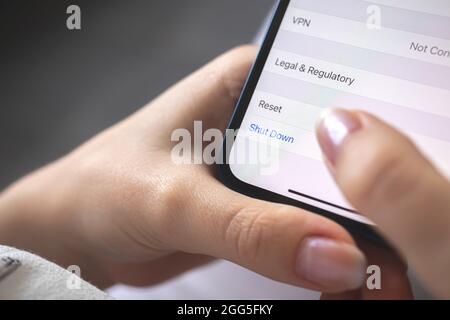 Person shut down the smartphone, mobile phone turn off concept photo, closeup Stock Photo