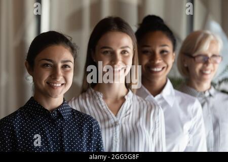 Head shot portrait successful motivated diverse businesswomen employees showing unity Stock Photo