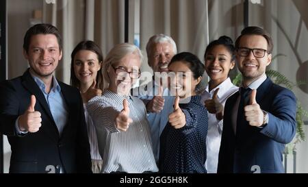 Happy successful diverse businesspeople employees group showing thumbs up Stock Photo