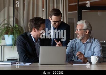 Excited colleagues working on online project, sharing ideas, having fun Stock Photo