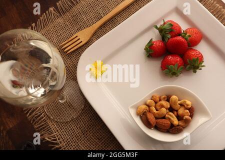 Mix nuts in bowls on wooden table. assorted nuts, pistachios, almonds, cashews, peanuts. diet and healthy eating concept Stock Photo