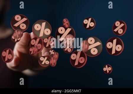 A  finger touching a digital concept of sales and discounts with floating percent signs in 3D Stock Photo
