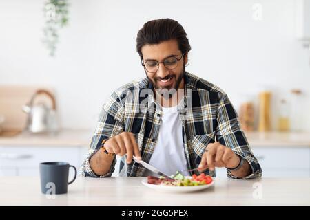 Positive arab guy having healthy breakfast at home Stock Photo