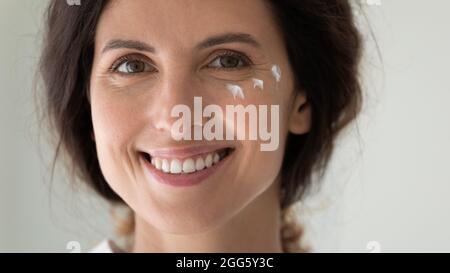 Close up headshot portrait of young woman with perfect skin. Stock Photo