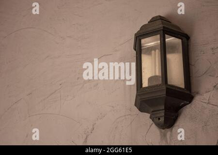 Wall metal lamp hanging at the exterior of a vintage building Stock Photo