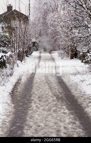 Tyre tracks in the slushy snow on a minor road Stock Photo - Alamy