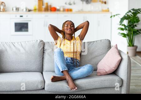 Dreamy afro american young woman resting at home Stock Photo