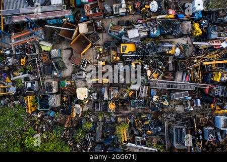 An aerial view looking down onto a scrapyard with scrap metal and vehicles with copy space Stock Photo
