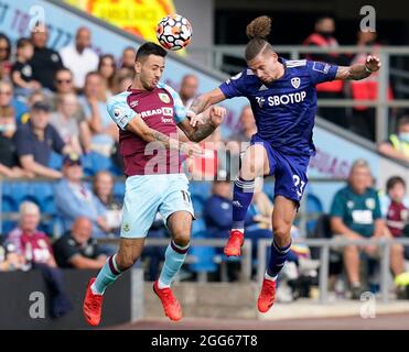 Burnley, England, 29th August 2021.  Dwight McNeil of Burnley challenged by Kalvin Phillips of Leeds United during the Premier League match at Turf Moor, Burnley. Picture credit should read: Andrew Yates / Sportimage Stock Photo