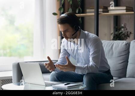 Focused online teacher giving webinar, virtual training form home Stock Photo
