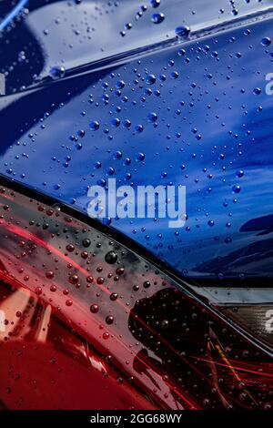 Raindrops or water droplets on the surface of the car. Stock Photo