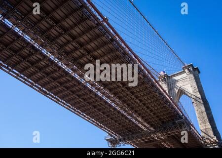 Underneath view from the Brooklyn bridge up on the East River. Crossing te bridge to Manhattan in New York city Stock Photo