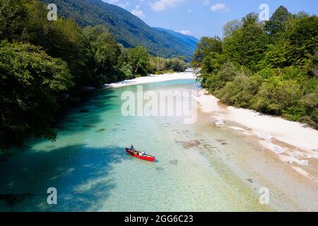 Aerial view of mother and son rowing in a red canoe on Soca river near Tolmin, Slovenia Stock Photo