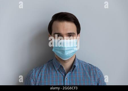 Millennial Caucasian man covering breathing organs from flu virus Stock Photo