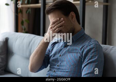 Tired bored guy feeling exhausted, suffering from lack of sleep Stock Photo
