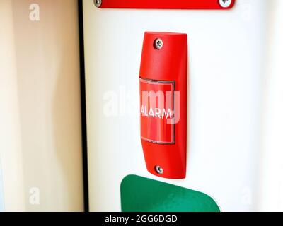 Red alarm button, public transport emergency safety switch, object closeup, nobody. City transportation vehicle interior, tram emergency button, secur Stock Photo