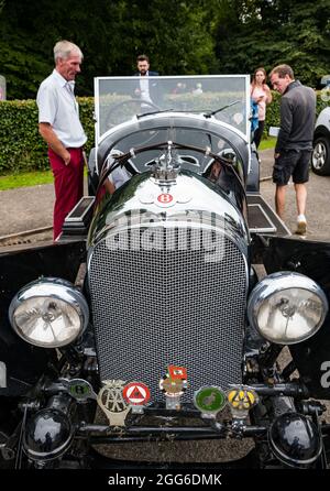 Newhailes, Musselburgh, East Lothian, Scotland, UK, 29th August 2021. Class car rally: an outdoor event takes place called Carhailes, with vintage cars on display. Pictured: People admire a vintage Bentley Stock Photo