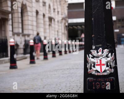 emblem and crest of the City of London on street bollard with Coat of arms of the City of London, with motto Domine dirige nos translated as Lord guide us Stock Photo