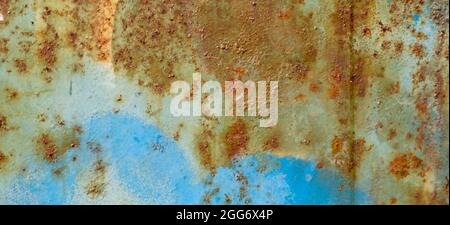 Multicolored background. Rusty metal surface with blue paint flaking and cracking texture Stock Photo