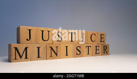 The word justice minister was created from wooden cubes. State and law Close up. Stock Photo