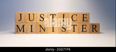 The word justice minister was created from wooden cubes. State and law Close up. Stock Photo