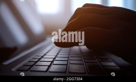 Close-up of hands of woman types on laptop Stock Photo