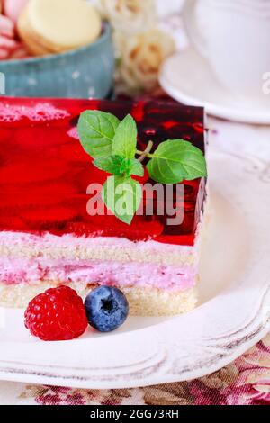 Layer fruit cake decorated with lemon balm leaf.  Party dessert Stock Photo