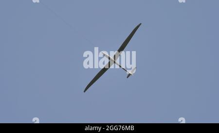 Thiene, Italy JULY, 8, 2021 Profile of a glider flying in the blue sky of a summer day. Copy space. Schempp-Hirth Duo Discus Stock Photo