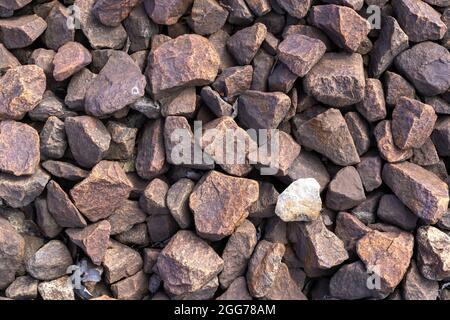 granite stone chips with a railway track color. Great industrial style background view Stock Photo