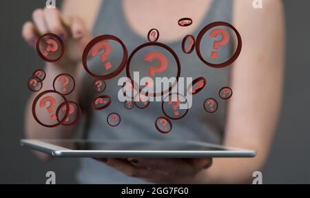 A digital concept of problem-solving with floating interogative marks on a pad Stock Photo
