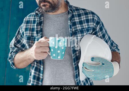 Construction engineer on a morning coffee break, relaxing and preparing for work Stock Photo