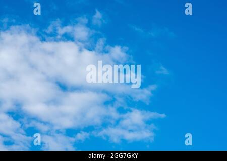 white clouds in bright blue sky Stock Photo