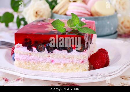 Layer fruit cake decorated with lemon balm leaf. Party dessert Stock Photo