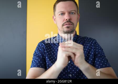 Young man folding his hands and pray Stock Photo