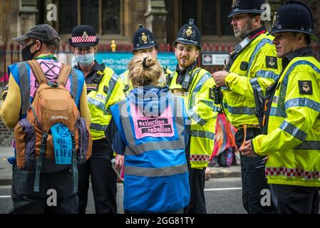 Friendly talk between the police and organisers, National Animal Rights March, organised by Animal Rebellion and  Extinction Rebellion in the City of London, England, UK. Several thousand people joined the group that campaigns to transition our food system to plant-based system in order to tackle the climate emergency.  August 28 2021 Stock Photo