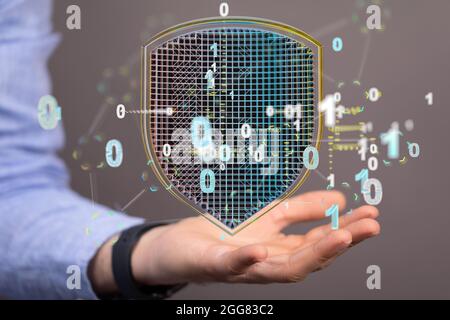 A 3D rendered futuristic shield with binary code hovering over a man's palm - cyber security concept Stock Photo