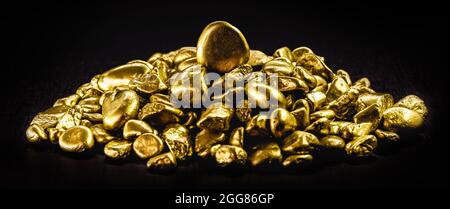 many gold nuggets on isolated black background, concept of wealth and rare ores Stock Photo