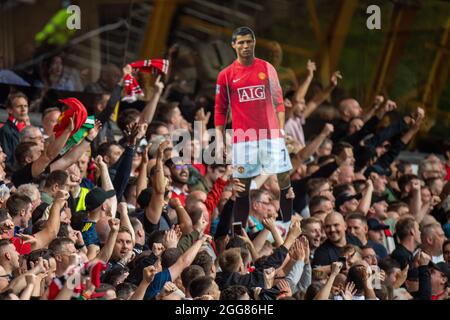 WOLVERHAMPTON, ENGLAND - AUGUST 29: Manchester United fans holding picture of Cristiano Ronaldo during the Premier League match between Wolverhampton Stock Photo