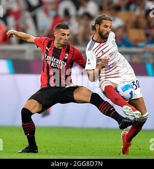 Milan. 30th Aug, 2021. AC Milan's Rade Krunic (L) vies with Cagliari's Leonardo Pavoletti during a Serie A football match between AC Milan and Cagliari in Milan, Italy, on Aug 29, 2021. Credit: Xinhua/Alamy Live News Stock Photo