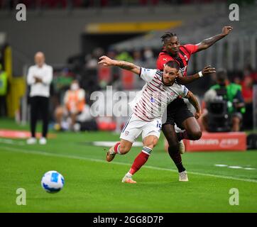 Milan. 30th Aug, 2021. AC Milan's Rafael Leao (R) vies with Cagliari's Nahitan Nandez during a Serie A football match between AC Milan and Cagliari in Milan, Italy, on Aug 29, 2021. Credit: Xinhua/Alamy Live News Stock Photo