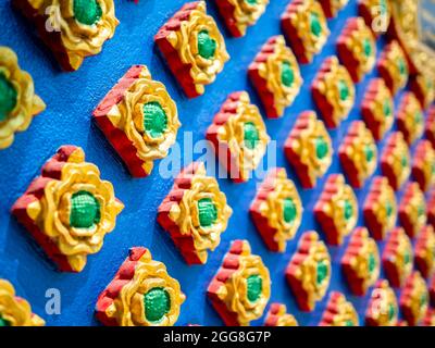 Beautiful Thai art stucco wall background. Close up Thai style of bas-relief stucco pattern. Stock Photo