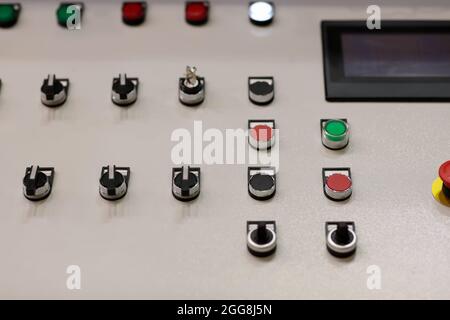 Pushbuttons, switches, and touchscreen on the control panel. Selective focus. Stock Photo