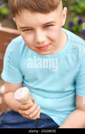 Pretty fun kid eating ice cream at park. Vacation concept. Staycation lifestyle Stock Photo